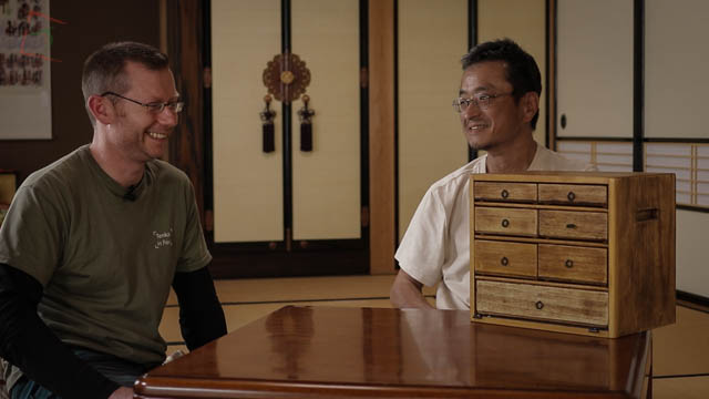 Kura-san giving me a privileged guided tour of his hand-made fly tying cabinet