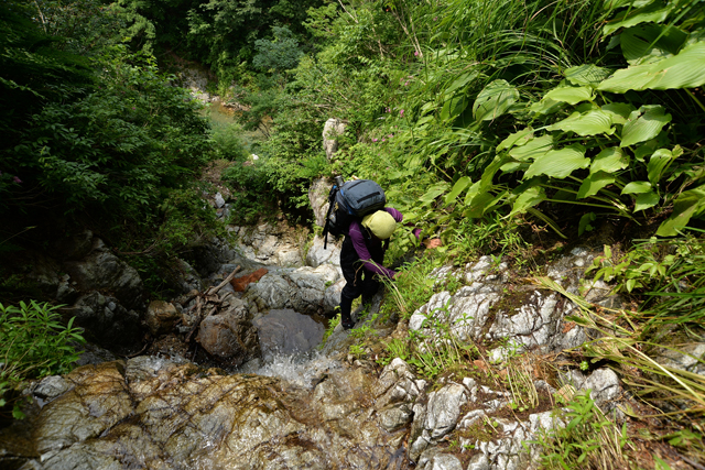 Climbing a steep cliff to reach a genryu fishing paradise