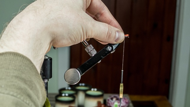 Altered angle of hand for offering materials to the hook in an underslung vise-head